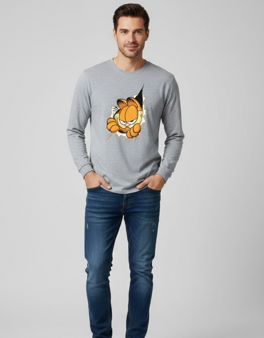 Man wearing a gray long-sleeve shirt with a cartoon character and blue jeans on a light gray background
