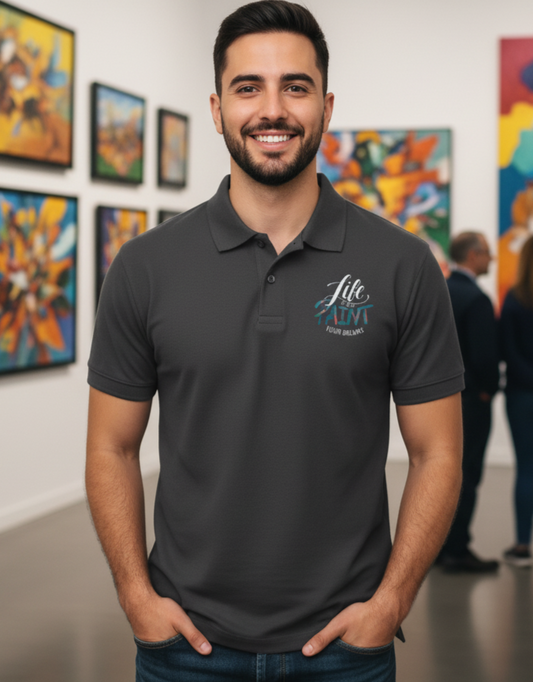 Man wearing a dark gray polo shirt with a logo in an art gallery