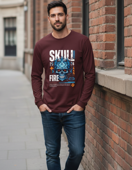 Man wearing a maroon sweatshirt with a graphic design, standing against a brick wall.